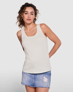 A light cream tank top displayed on a model paired with a denim skirt. The top features a simple design and has a logo.
