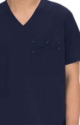 A navy blue medical scrub top featuring a chest pocket and stitching details. It includes a logo on the pocket.