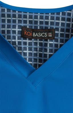 A blue V-neck top with a patterned inner lining and a label featuring a logo.