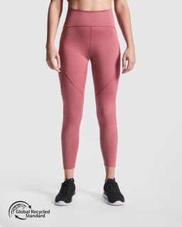 A pair of high-waisted leggings in a dusty rose colour, featuring a sleek design and a branding logo.