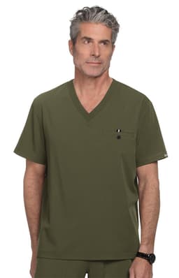 A man in a green scrubs top, featuring a V-neck and a pocket. The scrubs have a logo on the front.