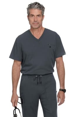 A grey V-neck scrub top with a pocket, worn by a man holding glasses. The design features a logo.