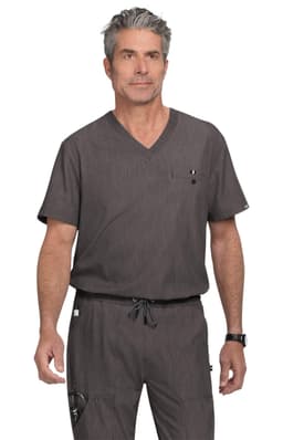 A man wearing a grey scrubs set with a V-neck top and drawstring pants, featuring a small pocket and branding.