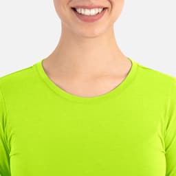 A close-up of a woman's neckline wearing a bright lime green underscrub tee, featuring a simple design and round neck.