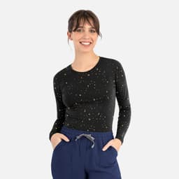 A long-sleeve women's underscrub tee in black with a starry pattern, featuring a fitted design and round neckline.