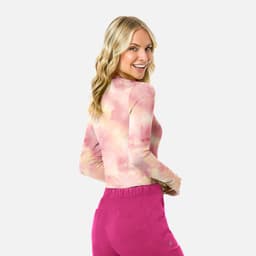 A long-sleeve women's underscrub tee in a tie-dye pattern of pink and muted tones, featuring a logo.
