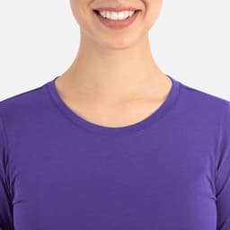 A purple women's underscrub tee with a round neckline, featuring a smiling model.