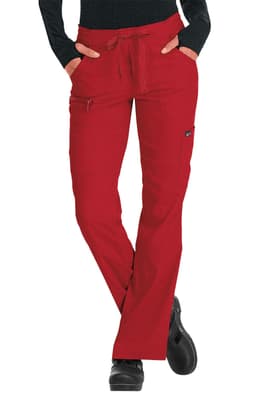 Red pants with a drawstring waist and pockets, designed for comfort and style. The model wears a black long-sleeved top.