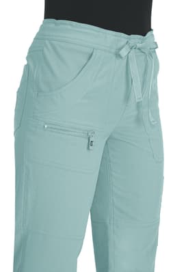 A pair of light mint green pants with pockets and a drawstring waist, featuring a zippered pocket.