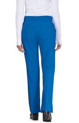 A woman standing with her back to the camera, wearing bright blue pants. The pants feature a waistband and pockets.