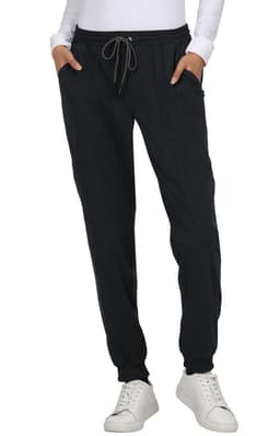 A pair of black jogger pants with pockets and a drawstring waistband, worn with a white long-sleeve top.