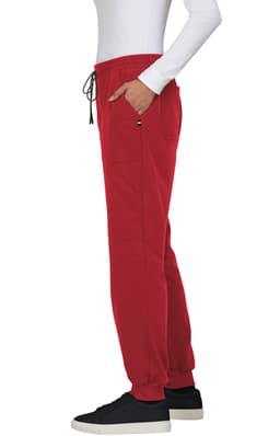 Red jogger pant displayed on a model, featuring side pockets and a drawstring waist, paired with a white long-sleeve top.