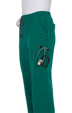 A pair of teal jogger pants with pockets, featuring a stethoscope tucked into one pocket.