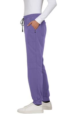 A pair of purple jogger pants with pockets and a drawstring waistband, worn with white sneakers.