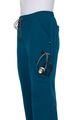 A pair of teal jogger pants featuring a pocket for a stethoscope and an adjustable waistband. It has a logo on the side.