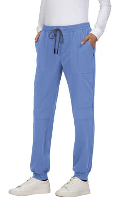 A pair of blue jogger pants with pockets, featuring an elastic waistband and drawstring, worn by a person.