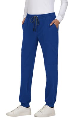 A pair of blue jogger pants with pockets and a drawstring waistband, featuring a logo, styled with a white top.