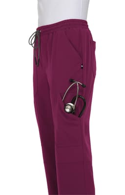 A pair of burgundy jogger pants featuring pockets, including one for a stethoscope, with a drawstring waist.