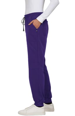 A pair of purple jogger pants featuring pockets and an elastic waistband. The pants are styled with a side view.