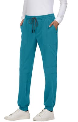 Turquoise jogger pants with a drawstring waist and side pockets, featuring a branding logo.