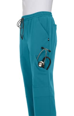A pair of teal jogger pants featuring a pocket hold a stethoscope. The pants have an elastic waistband and drawstring.