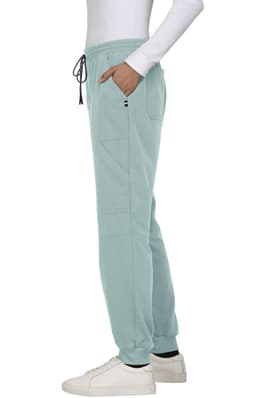 Light blue jogger pants featuring side pockets and a drawstring waistband, paired with white sneakers.
