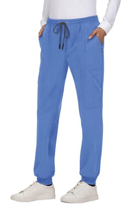 A pair of blue jogger pants featuring pockets and a drawstring waist, styled with a white top and sneakers.