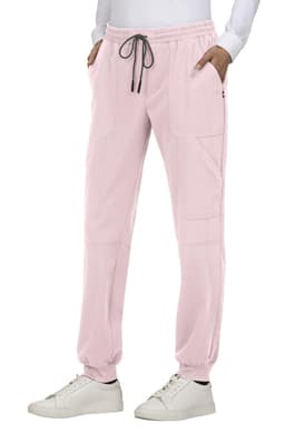 Light pink jogger pants with a drawstring waist, side pockets, and a branded logo located on the leg.