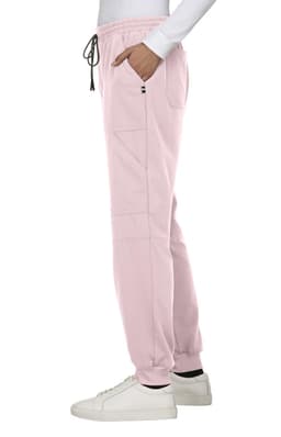 A pink jogger pant with a drawstring waist, featuring pockets and a logo, displayed on a model.