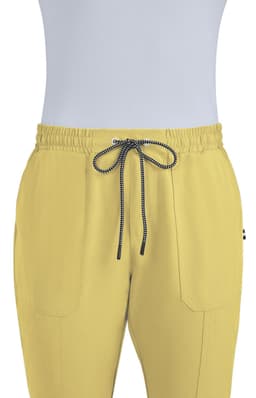 A pair of yellow jogger pants featuring an elastic waistband and drawstring, with two front pockets and a logo.