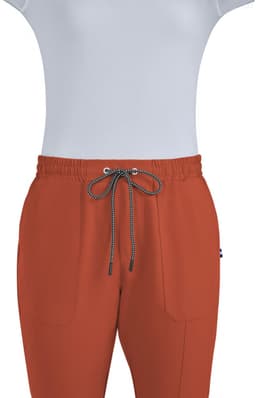 A pair of rust-coloured jogger pants with an elastic waistband and two front pockets, featuring a drawstring.