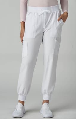 A pair of white jogger pants with pockets, featuring a drawstring waistband and elastic cuffs.