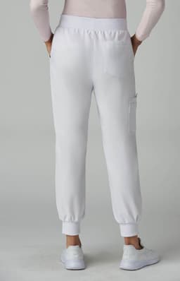 A pair of white jogger pants with elastic cuffs, featuring a back pocket. The model is facing away from the camera.