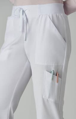 A pair of light grey jogger pants featuring pockets and a drawstring waistband. The pants have a branding logo.