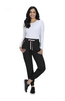 A pair of black jogger pants with a pink drawstring, displayed on a model wearing a white long-sleeve top.