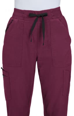 A pair of maroon jogger pants featuring black drawstrings and side pockets, with a logo present on one side.