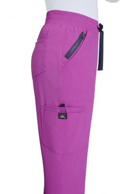 A pair of pink jogger pants with a side zipper pocket and a branding label on the waistband.
