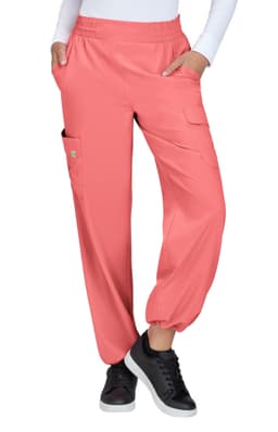 Coral cargo pants featuring pockets and an elastic waistband, worn with a white top and black sneakers.