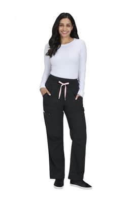 A woman wearing black wide-leg pants with a pink drawstring, paired with a long-sleeve white top and smiling.