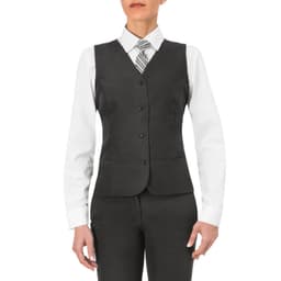 A woman wearing a grey Petra Vest over a white shirt, paired with a striped tie and black pants. The vest features buttons and a tailored fit.
