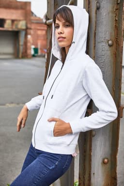 A white zip hoodie with a hood, featuring front pockets and a slight branding logo, worn by a model.