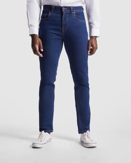 A pair of blue denim jeans with a slim fit and a light distressing at the hem, worn with white sneakers.