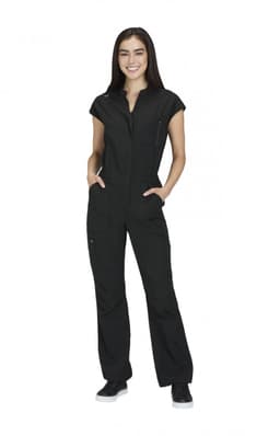 A black jumpsuit featuring short sleeves and zippered pockets, modelled by a smiling woman. It has a logo.