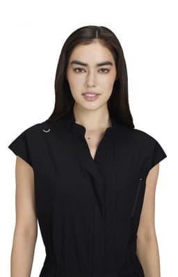 A black jumpsuit with short sleeves, a collar, and a front pocket, featuring a logo.