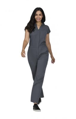 A jumpsuit in dark grey, featuring short sleeves and a relaxed fit, modelled by a woman walking.