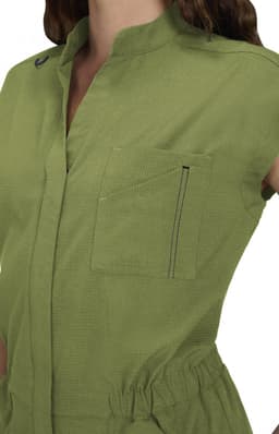 An olive green jumpsuit with a collar, short sleeves, and a front pocket. Features branding on the garment.