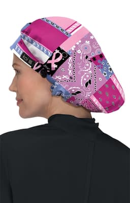 A bouffant scrub cap featuring a vibrant patchwork of pink and purple patterns with a logo.