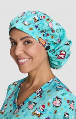 A bouffant scrub cap in turquoise with a playful print of cartoon characters and festive elements.