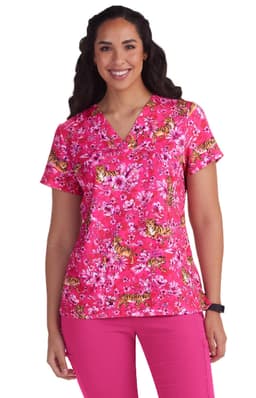 A pink floral scrub top featuring short sleeves, v-neckline, and a vibrant floral pattern.