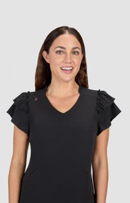 A black dress featuring ruffled sleeves and a V-neckline, displayed by a smiling woman. The dress has a logo on one shoulder.